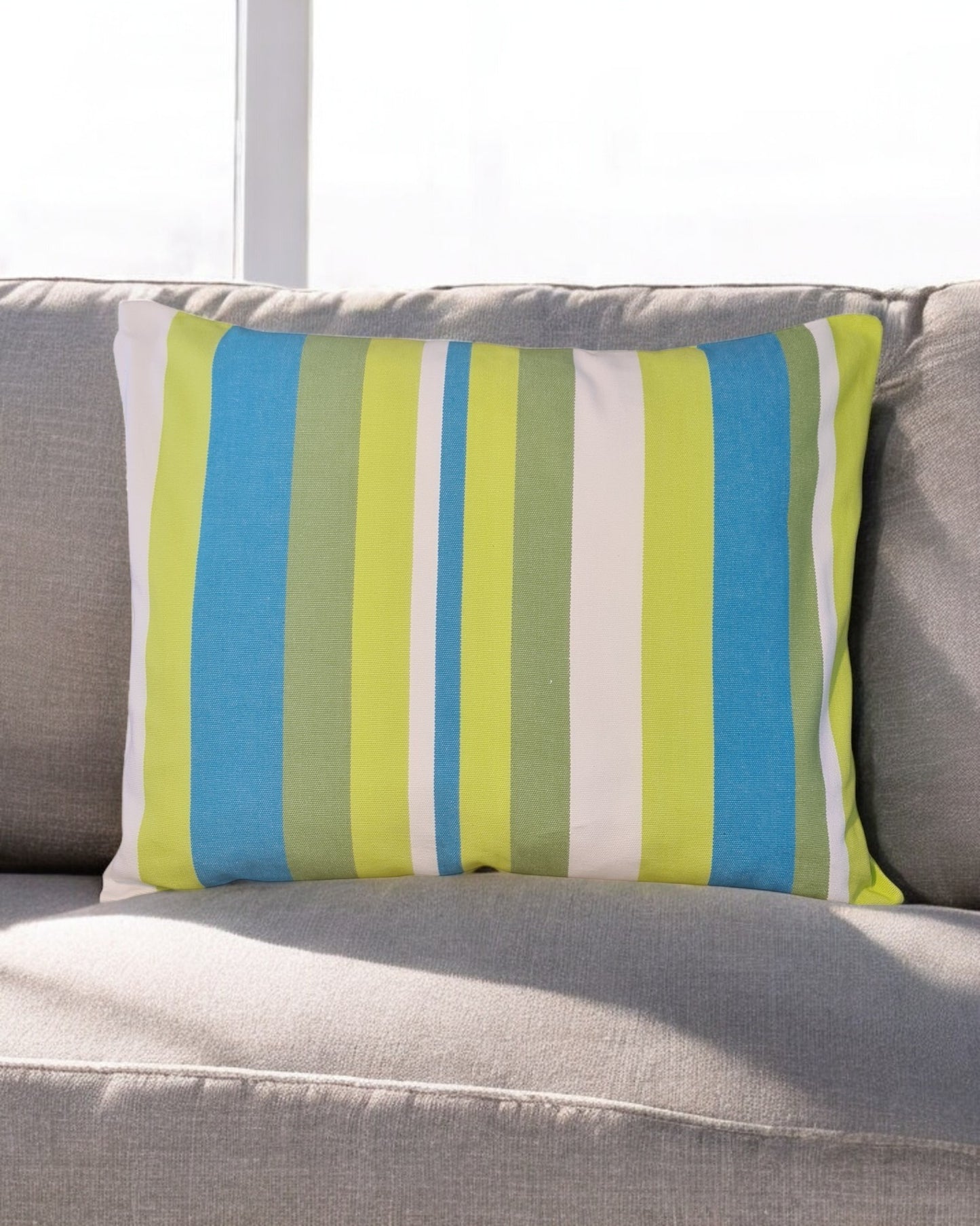 grün-blaues Kissen Brisa auf einem Sofa im Wohnzimmer aus 100% Baumwolle, hergestellt in Lateinamerika